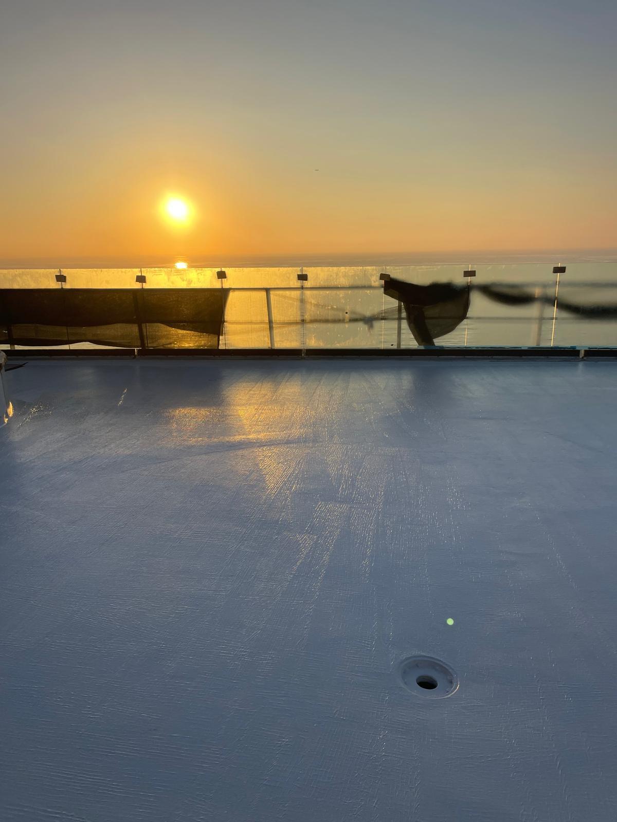 Roof terrace membrane at sunset overlooking the ocean