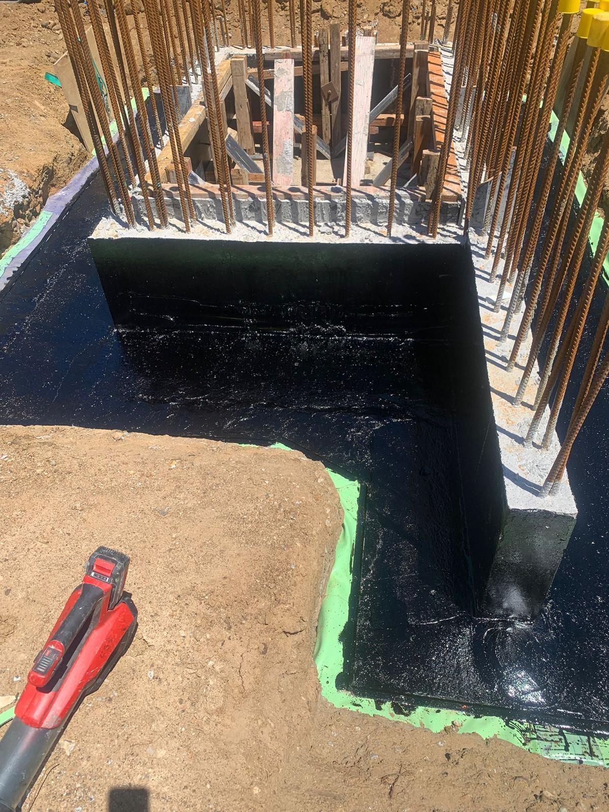 Lift pit walls and base coated in black tanking membrane