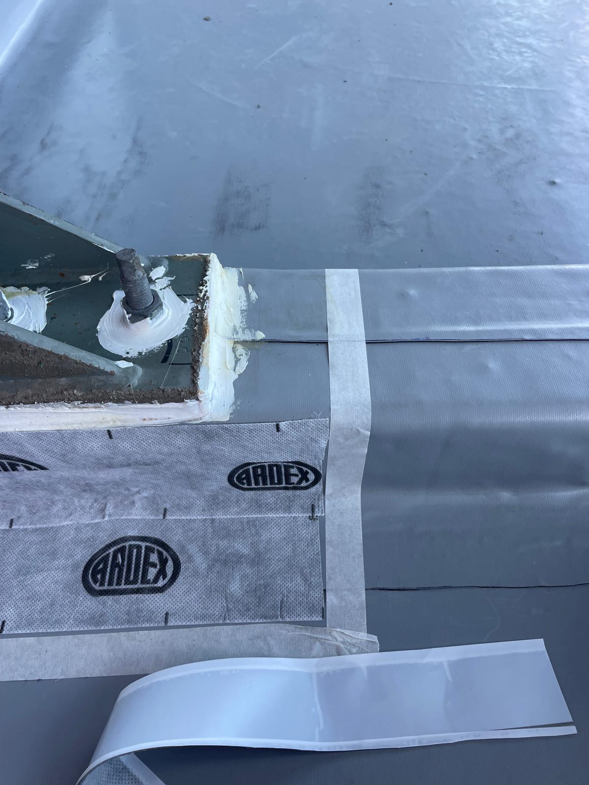 Membrane and bond breaker tape detailing around a bolted roof fixing