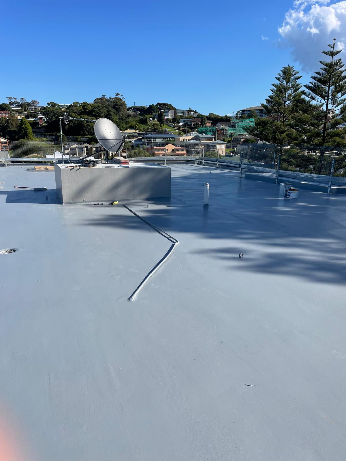 Roof deck sealed with grey membrane including joint detailing and penetrations
