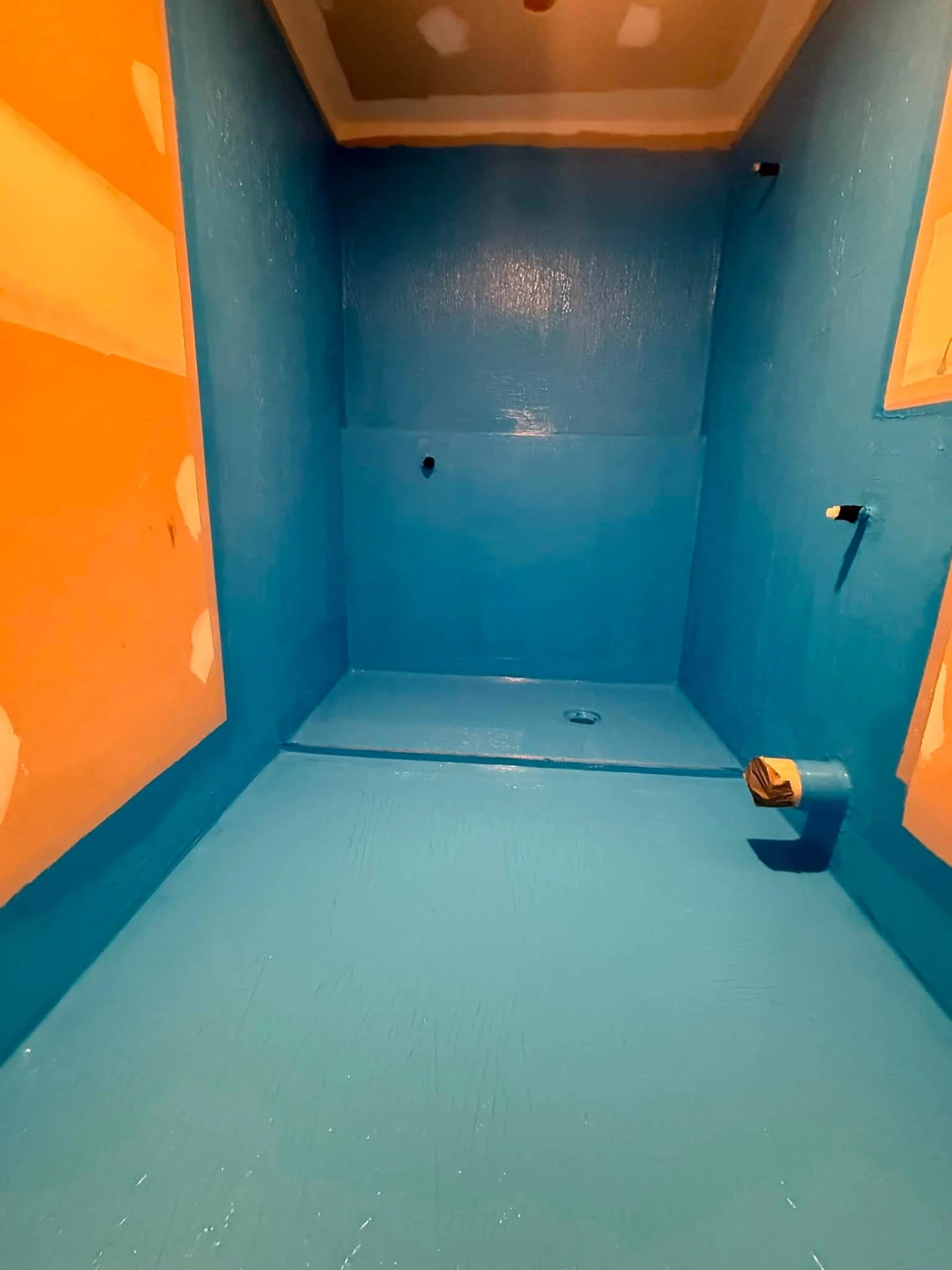 Shower recess fully coated in blue waterproofing membrane