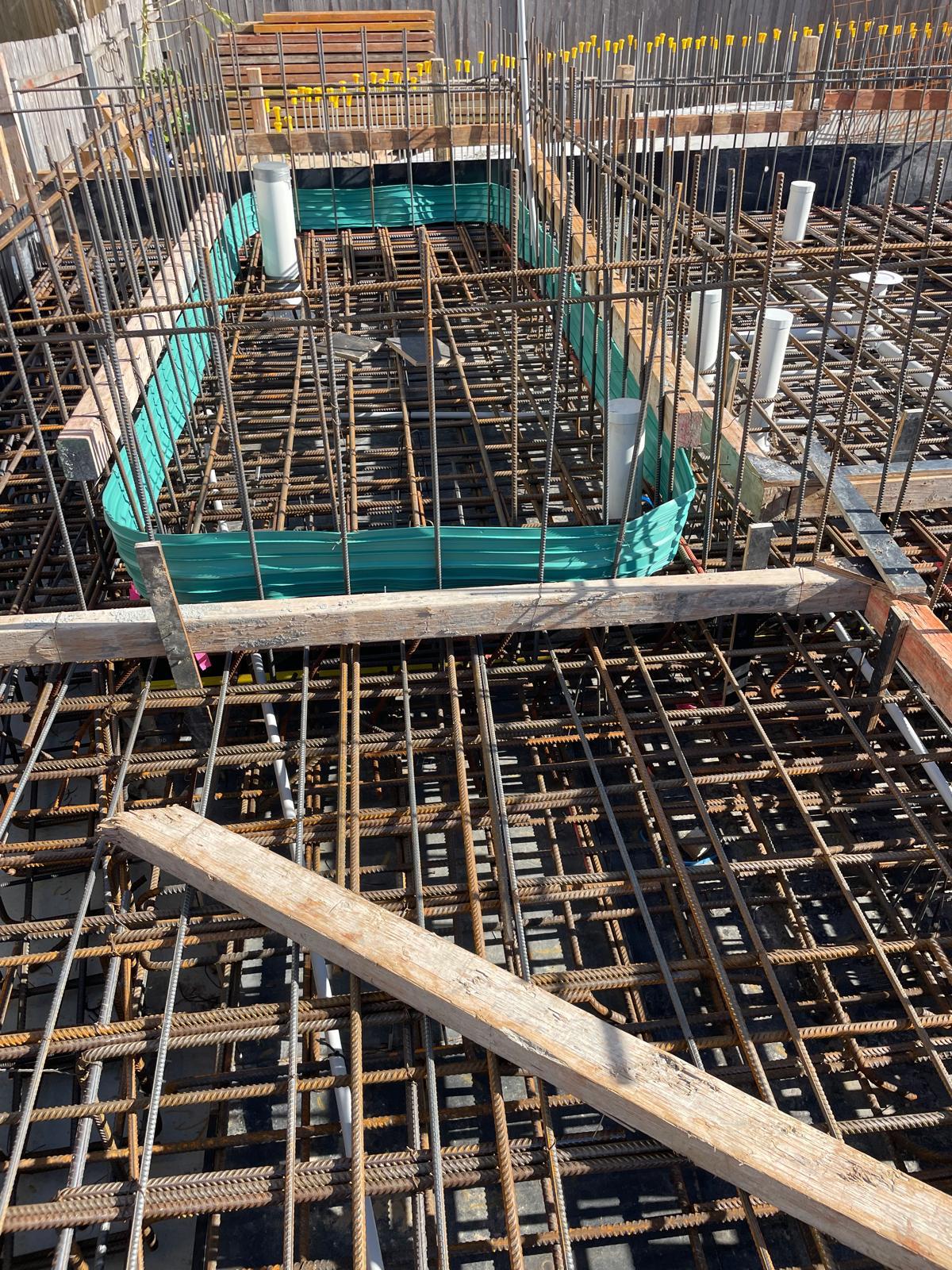 Lift pit and slab reinforcement over tanking membrane with sealed waterstop