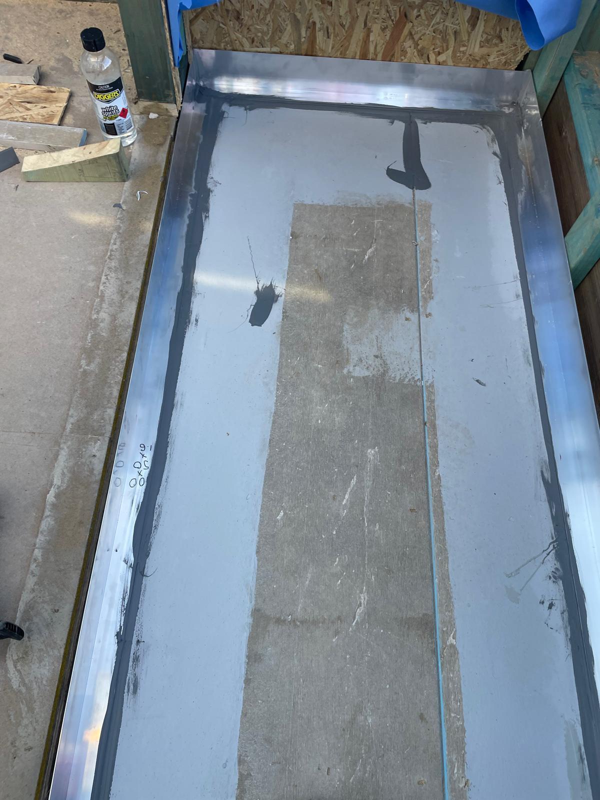 Balcony set down with metal angle flashing and grey membrane applied to the substrate