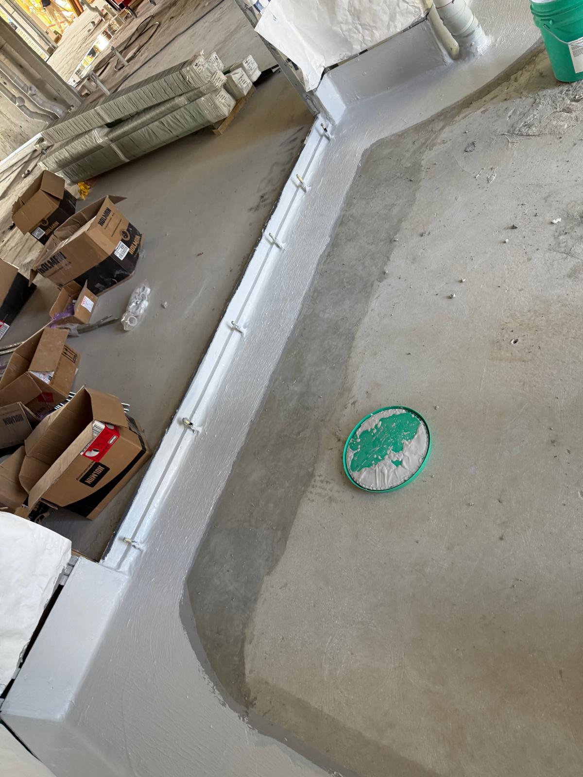 Set down slab edge and floor waste sealed with white waterproofing membrane