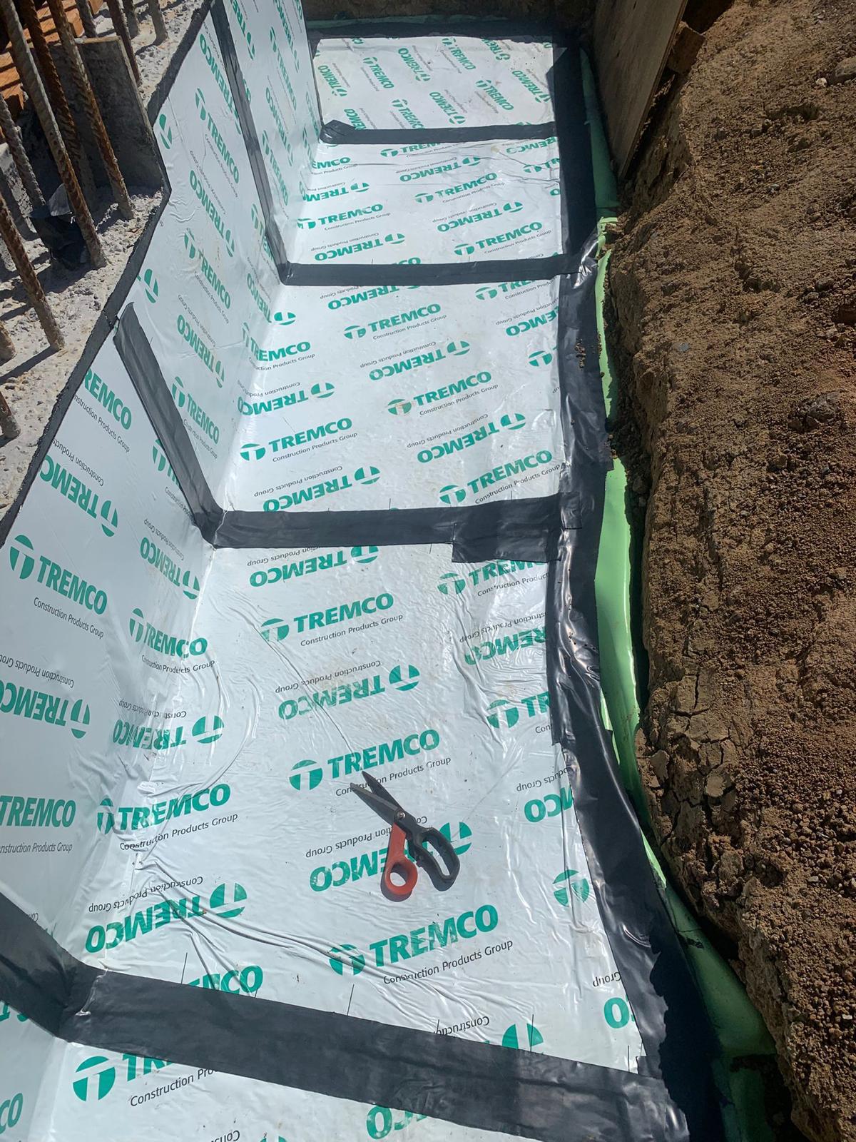 Below grade wall fully tanked with sheet membrane and sealed seams