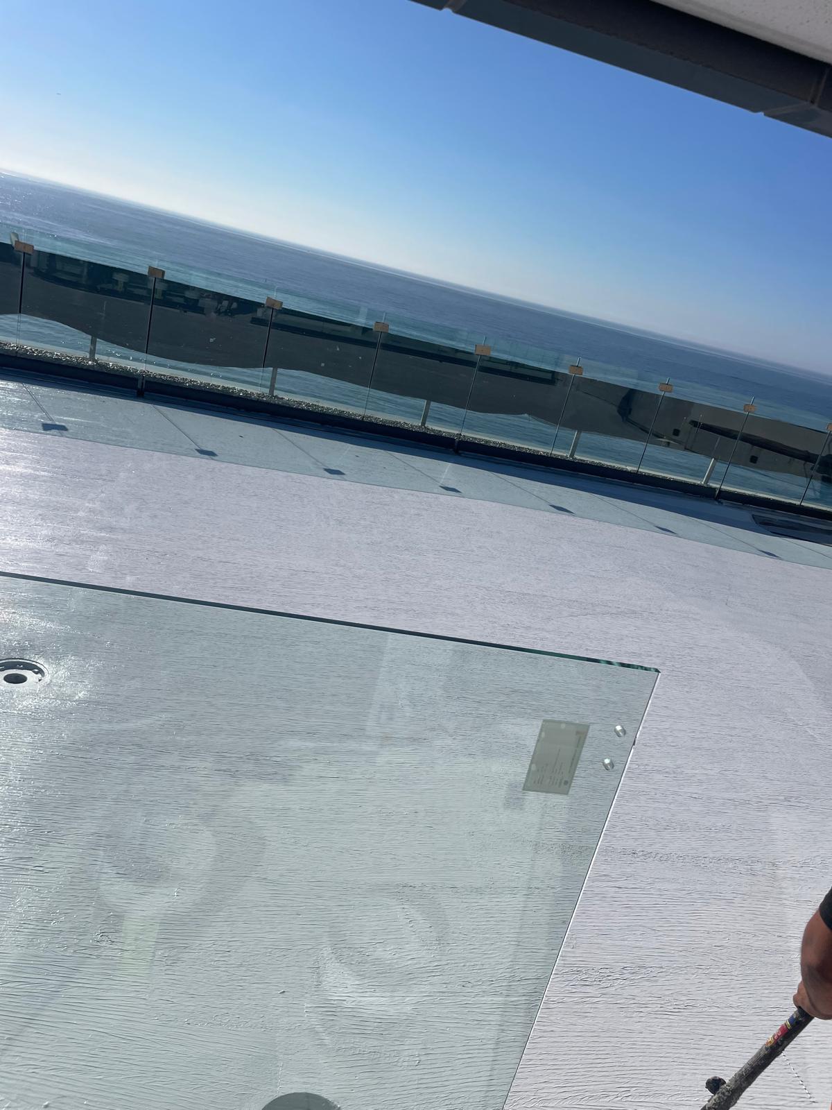 Oceanfront rooftop deck sealed with white waterproofing membrane